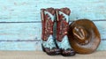 Cowboy boots and hat on a teal background Royalty Free Stock Photo