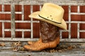 Cowboy Boots and Hat on Wooden Bench Royalty Free Stock Photo