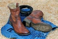 Cowboy boots leather belt and blue jeans on straw Royalty Free Stock Photo