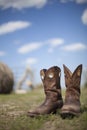 Cowboy boots in pasture Royalty Free Stock Photo