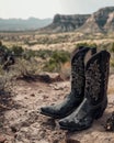 Cowboy boots in a rugged desert landscape