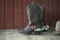 Cowboy boots, spurs and hat on old wood background Royalty Free Stock Photo