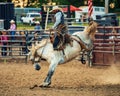 Cowboy bronco riding at the Wyandotte County Kansas Fair Rodeo Royalty Free Stock Photo