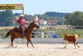 The Cowboy in a Calf roping competition. Royalty Free Stock Photo