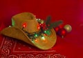 Cowboy Christmas.American West hat and bandanna on christmas red