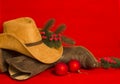 Cowboy Christmas.American West traditional boots and hat on christmas red background Royalty Free Stock Photo