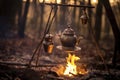 cowboy coffee pot hanging from tripod over fire Royalty Free Stock Photo