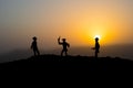 Cowboy concept. Silhouette of Cowboys at sunset time. A cowboy silhouette on a mountain with an yellow sky.