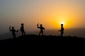 Cowboy concept. Silhouette of Cowboys at sunset time. A cowboy silhouette on a mountain with an yellow sky.