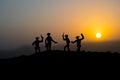 Cowboy concept. Silhouette of Cowboys at sunset time. A cowboy silhouette on a mountain with an yellow sky.