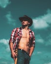 Cowboy couture. Portrait of young man wearing cowboy hat and looking up while standing against sky background. Fashion Royalty Free Stock Photo