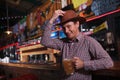 Cowboy drinking beer at the saloon