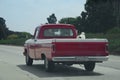 Cowboy drives red pickup truck Royalty Free Stock Photo