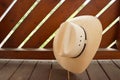 Cowboy hand leaning against wooden boards