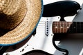 Cowboy hat on electronic guitar. White background. Country music concept or background. American culture. Royalty Free Stock Photo