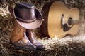 Cowboy hat guitar and boots in barn, country music festival live concert or rodeo background Royalty Free Stock Photo