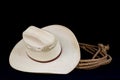 Cowboy hat and lasso on black