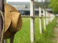 Cowboy hat and lasso on fence American ranch