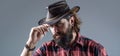 Cowboy Hat. Portrait of young man wearing cowboy hat. Cowboys in hat. Handsome bearded macho. Man unshaven cowboys Royalty Free Stock Photo