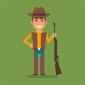 Cowboy holding hand on side holding gun and smiling
