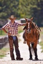 Cowboy, horse and portrait on farm in country and rodeo person on western ranch in nature. Trainer, confident and face