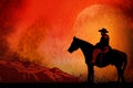 Cowboy on horse ride on sunset. Mountains on the horizon Royalty Free Stock Photo