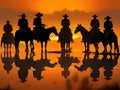 Cowboy on horseback at sunset.Silhouettes of men on horses Royalty Free Stock Photo