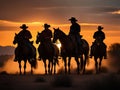 Cowboy on horseback at sunset.Silhouettes of men on horses Royalty Free Stock Photo