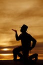 Cowboy kneel silhouette blow kiss Royalty Free Stock Photo