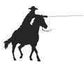 Cowboy with lasso riding a horse Royalty Free Stock Photo