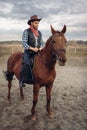 Cowboy In Leather Clothes Riding A Horse On Farm