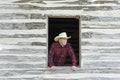 Cowboy Looking Out a Window Royalty Free Stock Photo