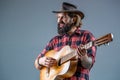 Cowboy playing guitar. Man cowboys playing acoustic guitars in wearing cowboy hat. Blues or country guitarist isolated Royalty Free Stock Photo