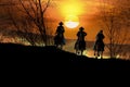 Cowboy riders at sunset Royalty Free Stock Photo