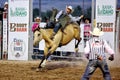 A cowboy rides a bucking bronco at the Warbonnet Roundup Rodeo Royalty Free Stock Photo