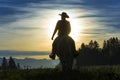 Cowboy riding across grassland