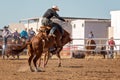 Cowboy Riding A Bucking Bronc Horse At A Country Rodeo Royalty Free Stock Photo