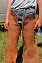 Cowboy in riding chaps at a roundup