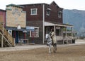 Cowboy Riding his horse into town Royalty Free Stock Photo