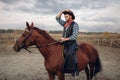 Cowboy riding a horse in desert valley, western Royalty Free Stock Photo