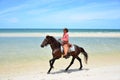 Cowboy is riding Horse walk on the beach