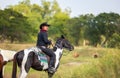 Cowboy`s way of life include riding a horse around locales Royalty Free Stock Photo