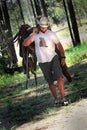 Cowboy with Saddle Royalty Free Stock Photo