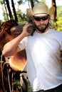 Cowboy with Saddle Royalty Free Stock Photo