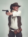 Cowboy, senior man and shooting gun, weapon or pistol in studio with costume isolated on a white background. Western Royalty Free Stock Photo