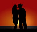 Cowboy Silhouette Couple at Coastal Sunset Royalty Free Stock Photo