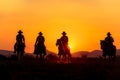 Cowboy silhouette riding a horse.