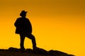 Cowboy silhouetted at dusk