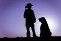 Cowboy & Sitting Dog Silhouette Royalty Free Stock Photo
