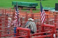 Cowboy Sitting on Red Fencing